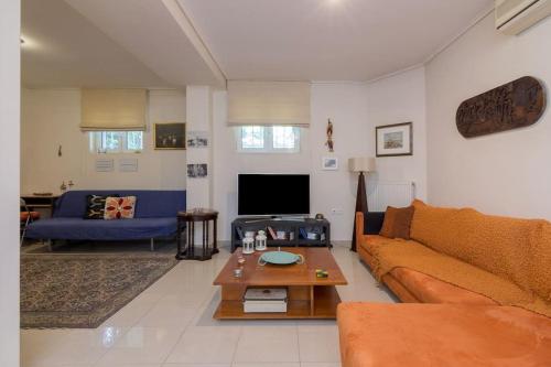 a living room with a couch and a table at Appartment in Nea Erithrea in Athens