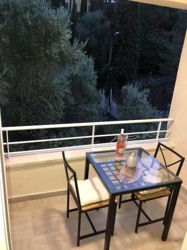 d'une table et de deux chaises sur un balcon avec une fenêtre. dans l'établissement T2 LA CIOTAT 60M2 AVEC TERRASSE EQUIPÉE, à La Ciotat