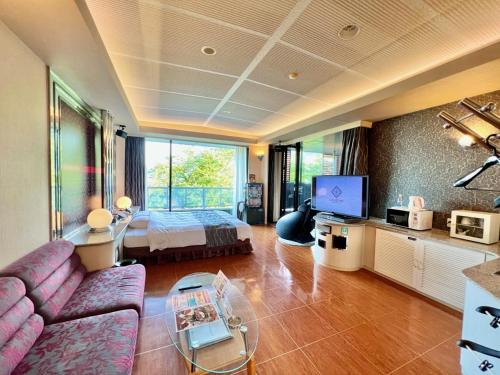 a living room with a couch and a bed at HOTEL In the Woods ,Love Hotel in Beppu