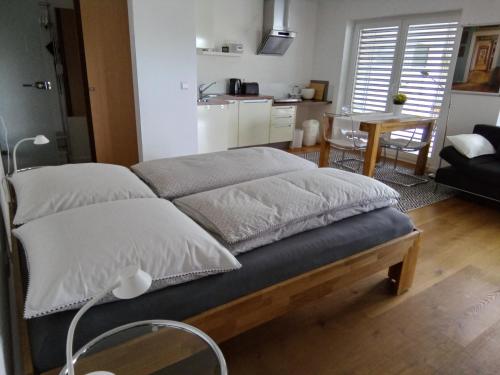 a bed with white pillows on it in a room at Ferienwohnung im Weinbergweg in Ravensburg