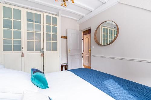 une chambre avec un lit et un miroir dans l'établissement Le Lilas - Hypercentre Confort Calme 4 voyageurs, à Dijon