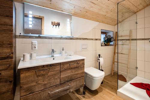 a bathroom with a sink and a toilet at Haus Franz und Haus Antje in Schönau am Königssee