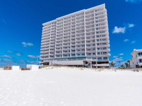 a large building on the beach with a sandy beach at Windemere #1104 in Perdido Key