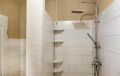 a shower in a bathroom with white tiles at Cozy Apartment In Wurster Nordseekste With Wifi in Hofe