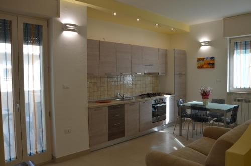 a kitchen and dining room with a table and a couch at La Stella di Gallipoli in Gallipoli