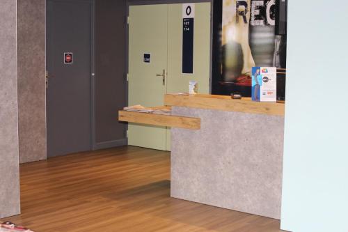 a counter in a room with a wooden floor at Hotel ibis Budget Laval in Bonchamp-lès-Laval