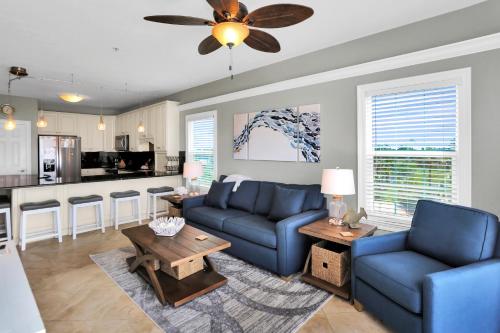 a living room with a blue couch and a table at Dunes Club 2A by Pristine Properties Vacation Rentals in Cape San Blas