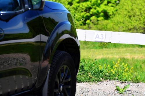 a car parked next to a fence with the number at Chilling On Orfű Apartman in Orfű