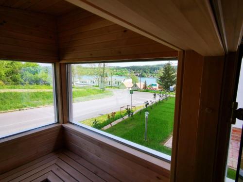 a window in a room with a view of a street at Chilling On Orfű Apartman in Orfű
