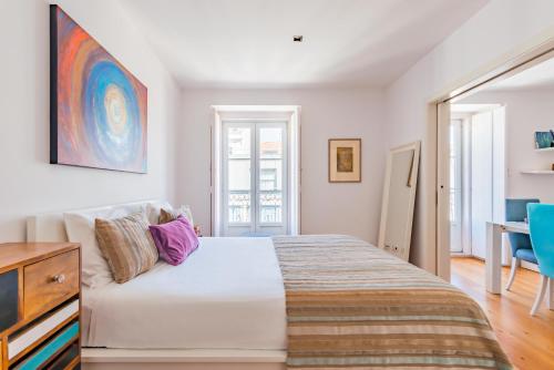 a bedroom with a large bed and a desk at Lisbon Prime Apartment in Lisbon