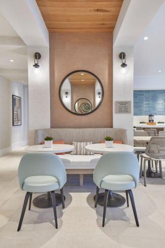 a waiting room with two chairs and a mirror at SpringHill Suites by Marriott Jacksonville Beach Oceanfront in Jacksonville Beach