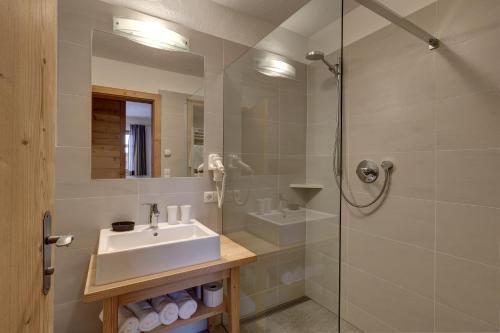 a bathroom with a sink and a shower at Schüsslerhof in Campo Tures