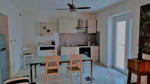 a kitchen with a table and chairs in a room at Residenza Bertolini in Fosdinovo
