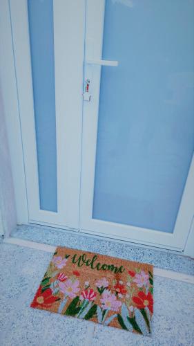 a welcome mat in front of a door at Residenza Bertolini in Fosdinovo