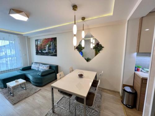 a living room with a blue couch and a table at Apartmani SLEEP&JOY in Zlatibor