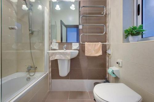 a bathroom with a toilet and a sink and a shower at Steps from the Sea, Side Sea-View, 3BR Sleep 6 in St. Paul's Bay