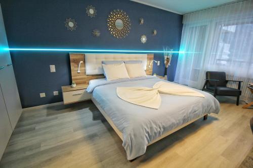 a bedroom with a large bed with blue lights at Ferien am Luganer See mit Seesicht in Bissone
