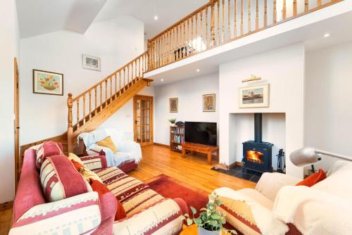 uma sala de estar com mobiliário e uma lareira em Cottage 118 - Cleggan em Cleggan