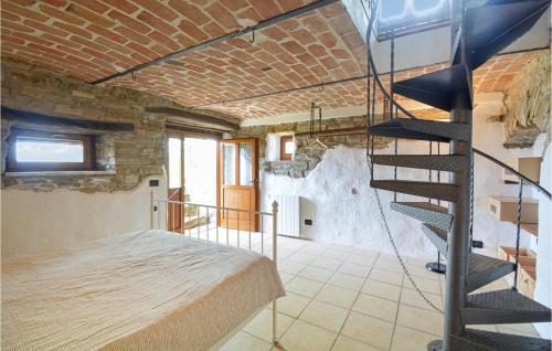 a room with a bed and a spiral staircase at Lovely Apartment In Monastero Bormida in Monastero Bormida