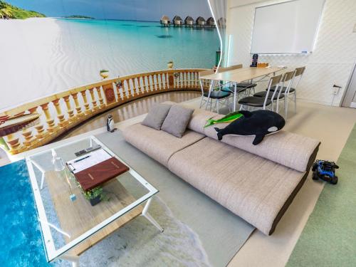 a living room with a couch and a table and water at Omotenashi Hostel Miyajima in Hatsukaichi