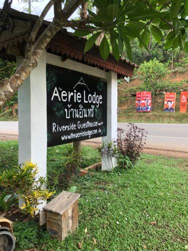 a sign on the side of a road with a bench at Aerie Lodge in Pang Mapha