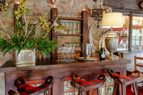 a room with a bar with chairs and a table at Masia Mimosa in Darnius