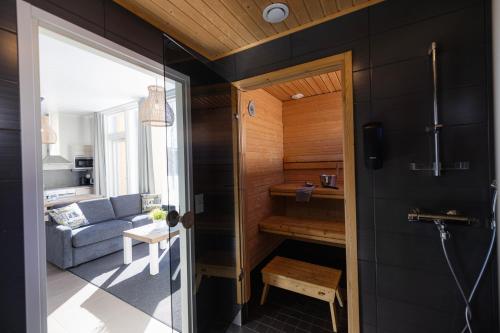 a tiny house with a glass door leading into a living room at Nallikari Holiday Village Villas in Oulu