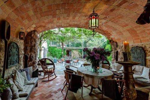 a room with a table and chairs and a brick wall at Masia Mimosa in Darnius