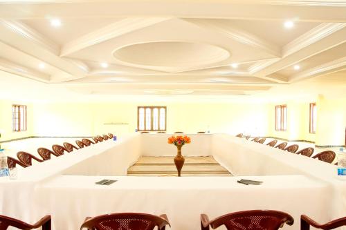 a conference room with a table and chairs at Hotel SV International in Kodaikānāl