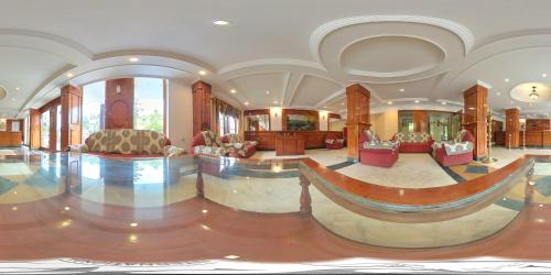 uma grande sala com um átrio com cadeiras e mesas em Hotel SV International- Powered by Stayflexi em Kodaikanal