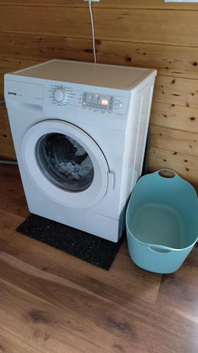 a white washing machine sitting next to a bowl at Fuchsbauerhof - Ferienwohnung in Kniezenberg