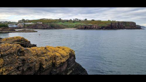 a view of a body of water with a rocky shore at Sandy Cove in Dunmore East
