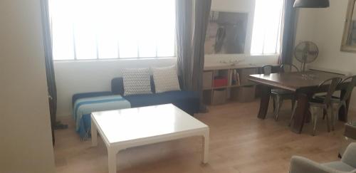 un salon avec un canapé et une table dans l'établissement Charming Loft - Tour Eiffel/ Rue Cler, à Paris