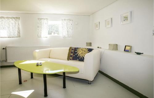 a living room with a white couch and a table at Holiday Home Hörby Xiii in Hörby