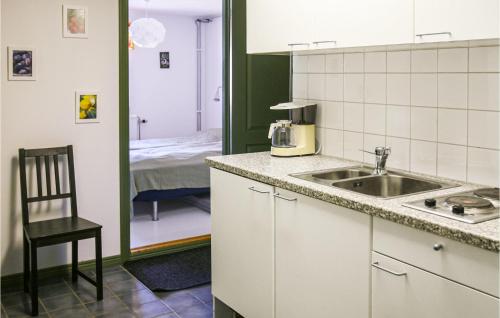 a kitchen with a sink and a room with a bed at Holiday Home Hörby Xiii in Hörby