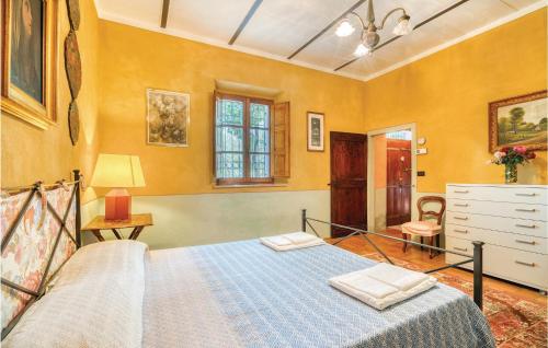 a bedroom with a bed in a room with yellow walls at Roseto Immacolata in Roccastrada