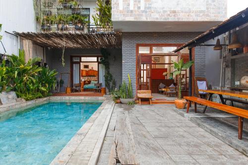 a swimming pool in the middle of a house at Chaca Beach House in Da Nang