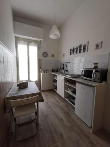 a kitchen with a table and a counter top at Residenza Gelas in Cuneo