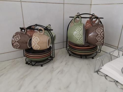 three vases sitting on a rack in a bathroom at Residenza Gelas in Cuneo