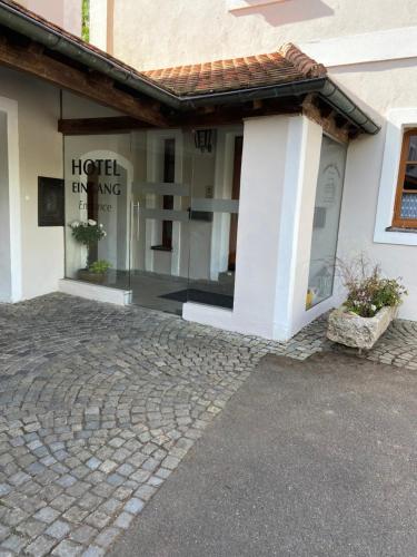 a building with a window with a hotel entrance at Landhotel Kahrmühle in Pressath