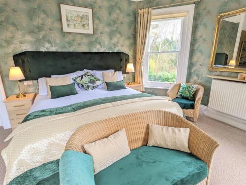 a bedroom with a large bed and a window at Foxhills of Shanklin in Shanklin