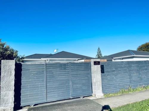 a large metal garage door in front of a house at Amber Hill A in Pukekohe East