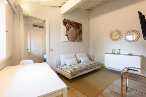 a living room with a couch and a mirror at Santa Croce Top by Mmega in Florence