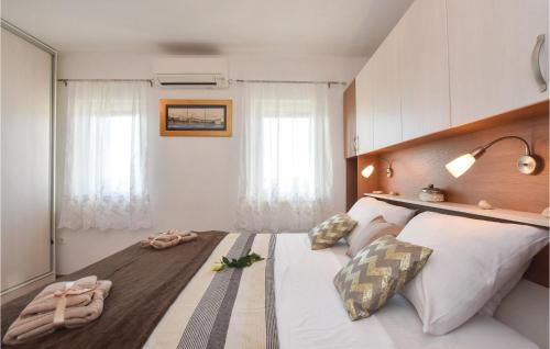 a bedroom with a large bed with two pillows at Lovely Home In Split With Jacuzzi in Split
