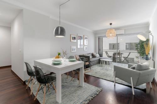 a living room with a white table and chairs at Santa Catarina II by An Island Apart in Funchal