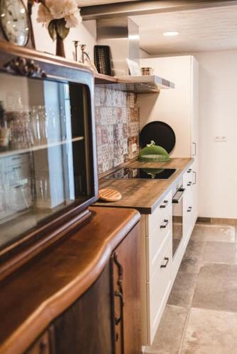 a kitchen with white cabinets and a counter top at Ferienhof Greuthof in Bad Wurzach
