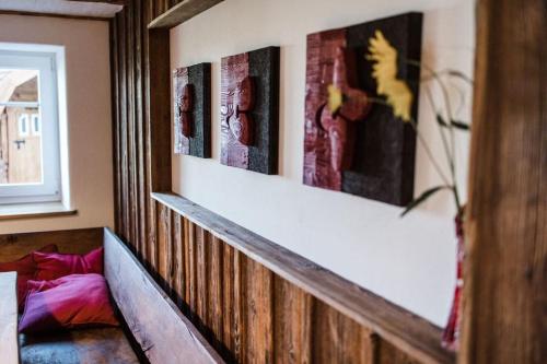 a room with three paintings on the wall at Ferienhof Greuthof in Bad Wurzach