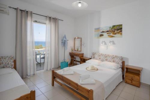 a bedroom with a bed and a view of the ocean at Creta Sun Mochlos in Mochlos