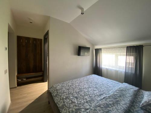 Un dormitorio con una cama azul y una ventana en Панорамні апартаменти, en Uzhhorod