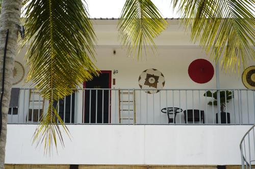 a white house with a palm tree in front of it at WHITE SAND ARK RESORT in Koh Rong Island